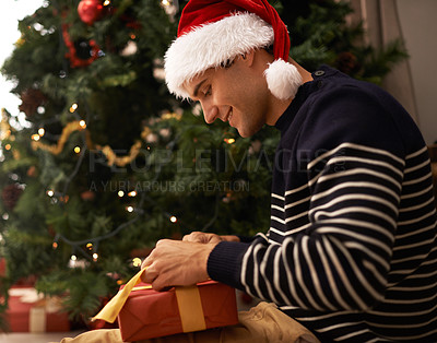 Buy stock photo Shot of a handsome young man getting ready for Christmas