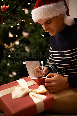 Buy stock photo Shot of a handsome young man getting ready for Christmas