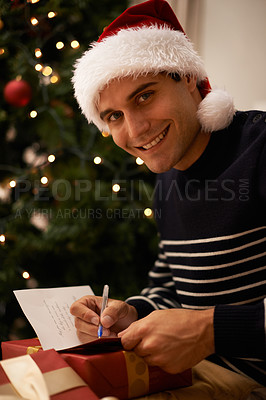 Buy stock photo Shot of a handsome young man getting ready for ChristmasShot of a handsome young man getting ready for Christmas