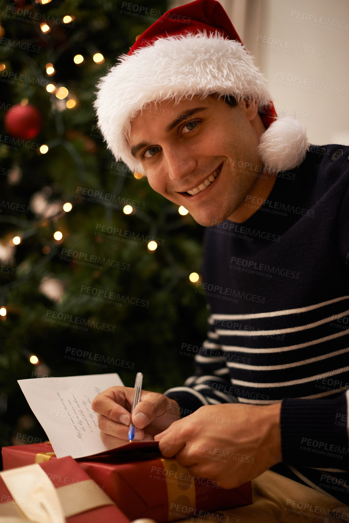 Buy stock photo Shot of a handsome young man getting ready for ChristmasShot of a handsome young man getting ready for Christmas