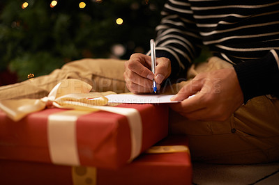 Buy stock photo Pen, hands and man with card and present for Christmas event or party at home for family. Celebration, paper and closeup of male person writing letter with gift boxes for xmas festive holiday.