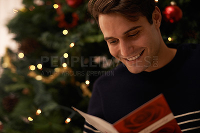 Buy stock photo Shot of a handsome young man getting ready for Christmas