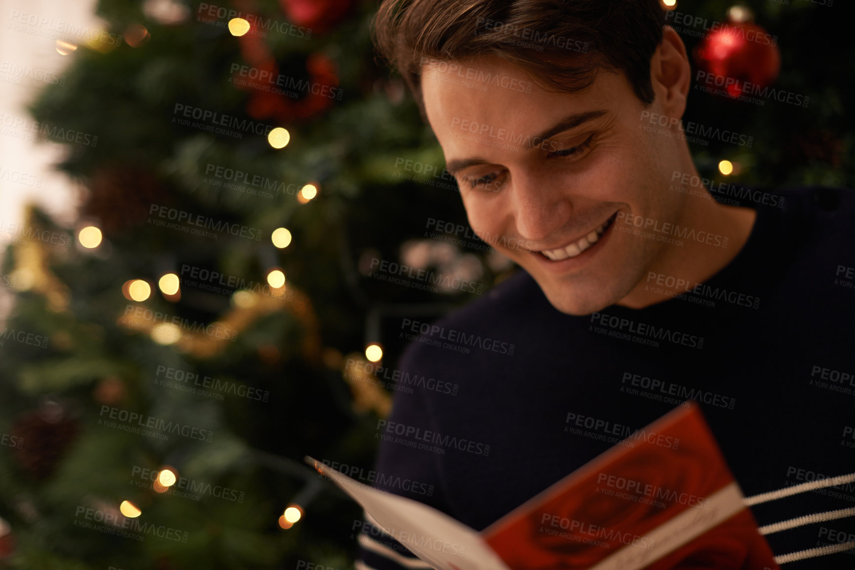 Buy stock photo Shot of a handsome young man getting ready for Christmas