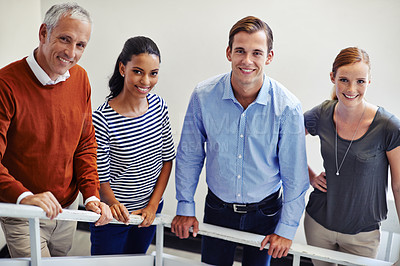 Buy stock photo Shot of a group of colleagues standing on a staircase