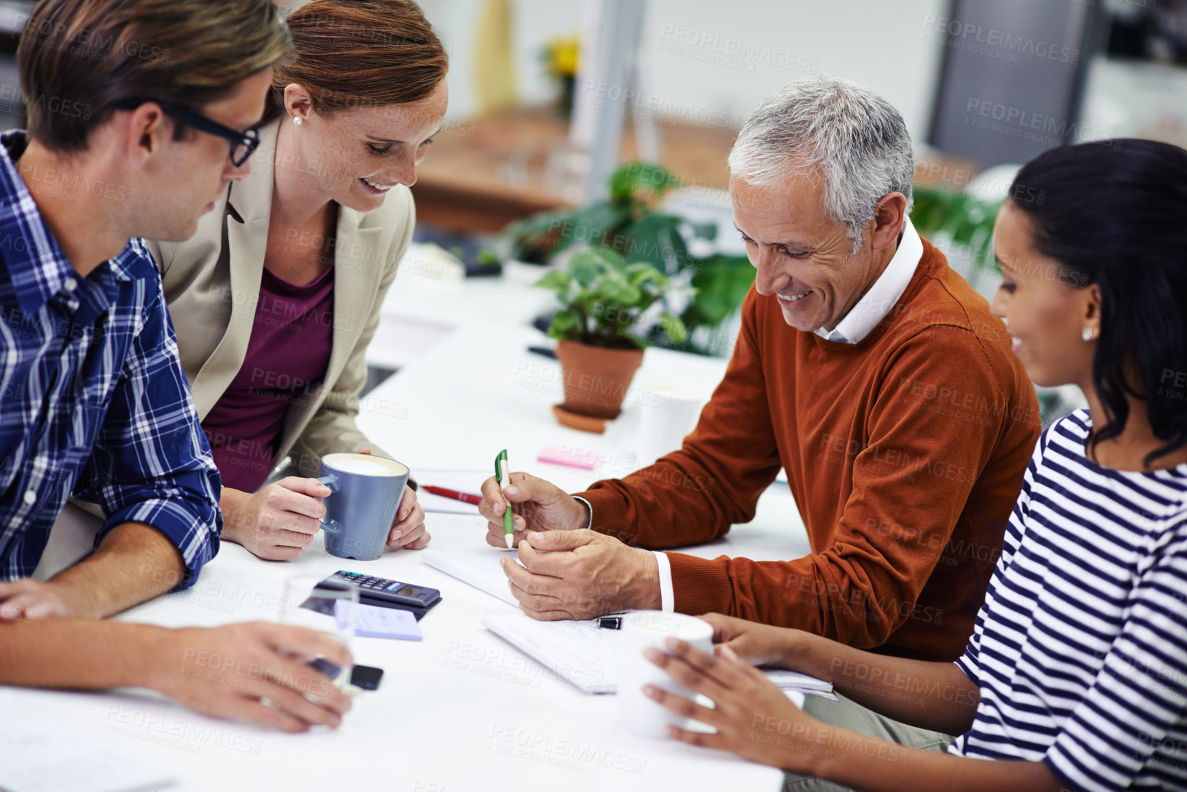 Buy stock photo A cropped shot of a group of professionals having a meeting at work