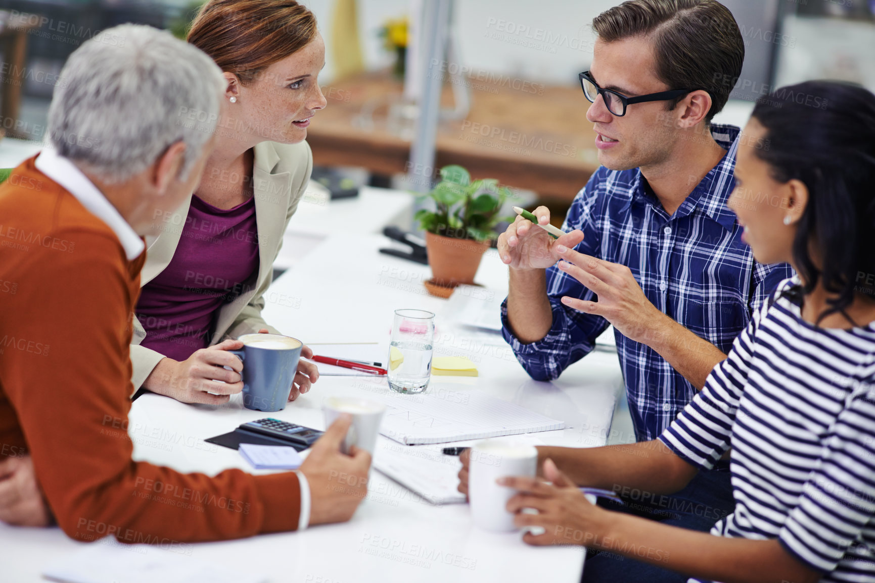 Buy stock photo A cropped shot of a group of professionals having a meeting at work