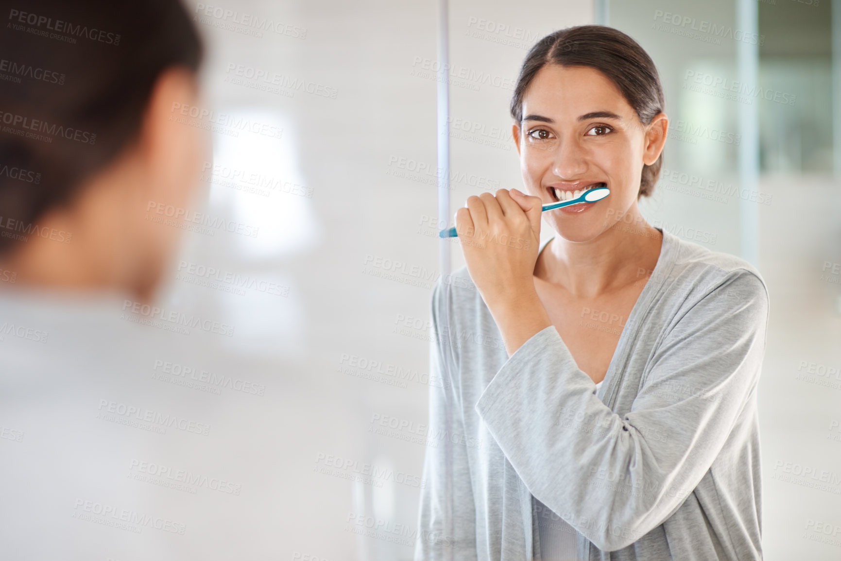 Buy stock photo A young woman brushing her teeth