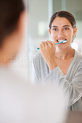Buy stock photo Woman, brushing teeth and smile in home by mirror for health, wellness or self care for breath in morning. Girl, person and happy with toothbrush, mouth and cleaning for hygiene at apartment in Chile