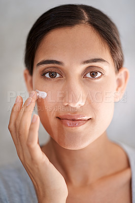 Buy stock photo Portrait, skincare and lotion with woman in bathroom of home for morning facial or antiaging routine. Face, beauty and cream with confident young person in apartment to apply moisturizer to skin