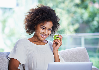 Buy stock photo Laptop, smile and happy woman with apple, sofa and home lounge for relax and online. Technology, computer and scrolling on social media website, app or internet for  connection with healthy snack