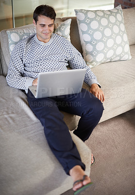 Buy stock photo Relax, happy or man on laptop for download, article post or networking in home to research. Email, smile or male person on sofa typing online on technology for streaming, movie or news on website