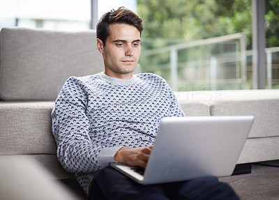Buy stock photo Man, home and couch with typing on laptop for remote work as freelancer with startup business and online research. Male person, living room and browse on internet with information for project