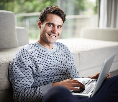 Buy stock photo Portrait of a handsome young man using his laptop