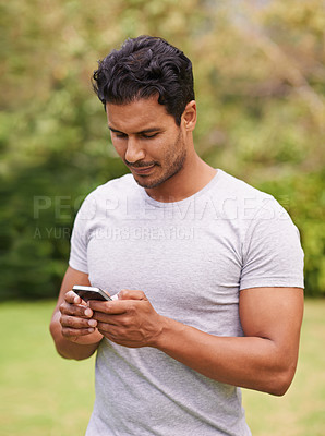 Buy stock photo Man, outdoor and phone on grass, browse and watching social media or meme for entertainment in nature. Male person, backyard and tech to relax, scroll and vacation at home or house for peace 
