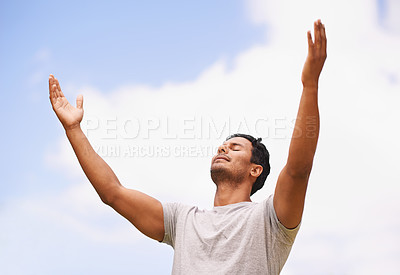 Buy stock photo Shot of a man with his arms outstretched to the sky