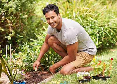 Buy stock photo Portrait of a handsome young man working in his garden