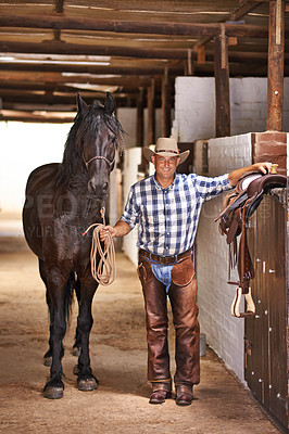 Buy stock photo Shot of a cowboy on a farm
