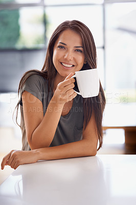 Buy stock photo Shot of an attractive young woman drinking a coffee at home