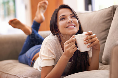 Buy stock photo Woman, coffee and thinking on sofa with smile for relax weekend contemplation for holiday, carefree or peace. Female person, beverage and thoughts on home couch in Mexico or calm, resting or vacation