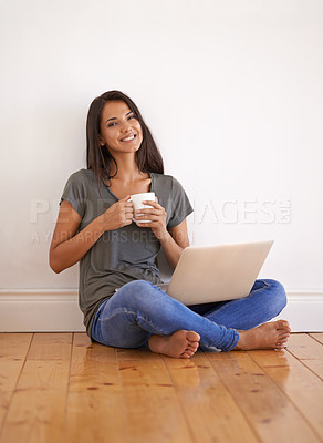 Buy stock photo Wall background, laptop and woman with coffee on floor of apartment, home and smile with mug. Happiness, female person and girl watching movies on site of app online with technology and internet