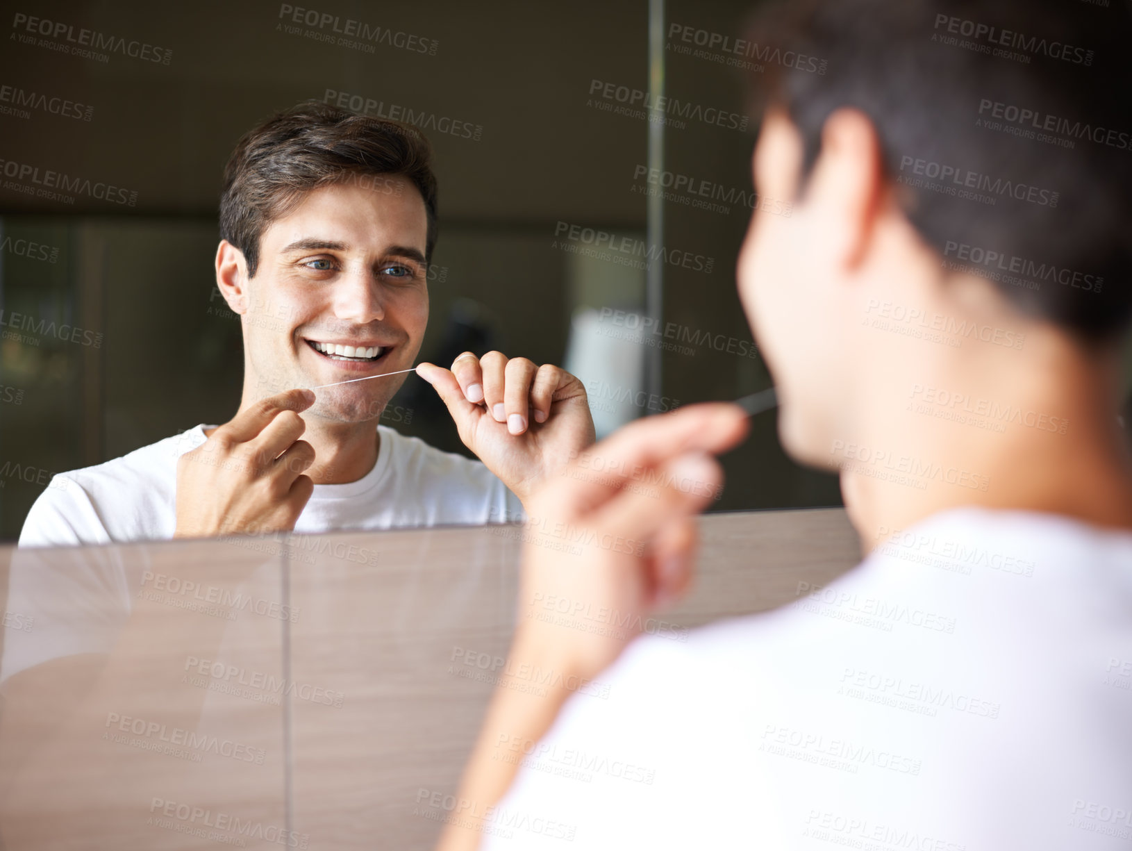 Buy stock photo Happy man, teeth and dental care with floss for hygiene, grooming or freshness in bathroom mirror at home. Face of handsome male person with smile in routine for oral, mouth or gum cleaning at house