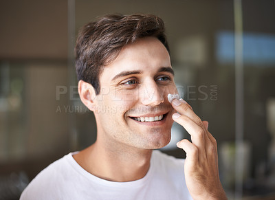 Buy stock photo Beauty, skincare and face of man with cream in bathroom for facial treatment, wellness and grooming. Dermatology, healthy skin and happy male person with lotion, creme and moisturizer for hygiene