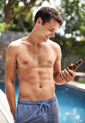 Buy stock photo Man, look and happy by swimming pool with beer to relax or chill on summer vacation, luxury and resort or villa. Male person, bottle and alcohol for refreshments on tropical holiday in Maldives.