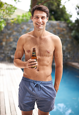 Buy stock photo Portrait, man and happy by swimming pool with beer to relax or chill on summer vacation, luxury and resort or villa. Male person, bottle and alcohol for refreshments on tropical holiday in Maldives.