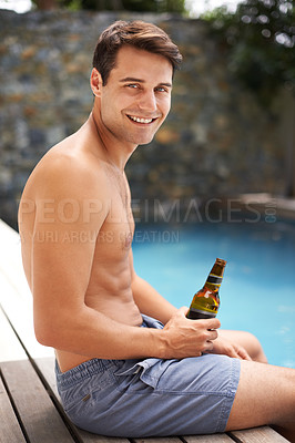 Buy stock photo Man, relax and happy by swimming pool with beer to drink or chill on summer vacation, luxury and resort or villa. Male person, bottle and alcohol for refreshments on tropical holiday in Maldives.