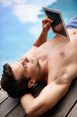 Buy stock photo Man, tablet and relax by swimming pool on internet for summer holiday or serious outdoor. Water, digital technology and person on vacation on social media app, networking or reading website on screen