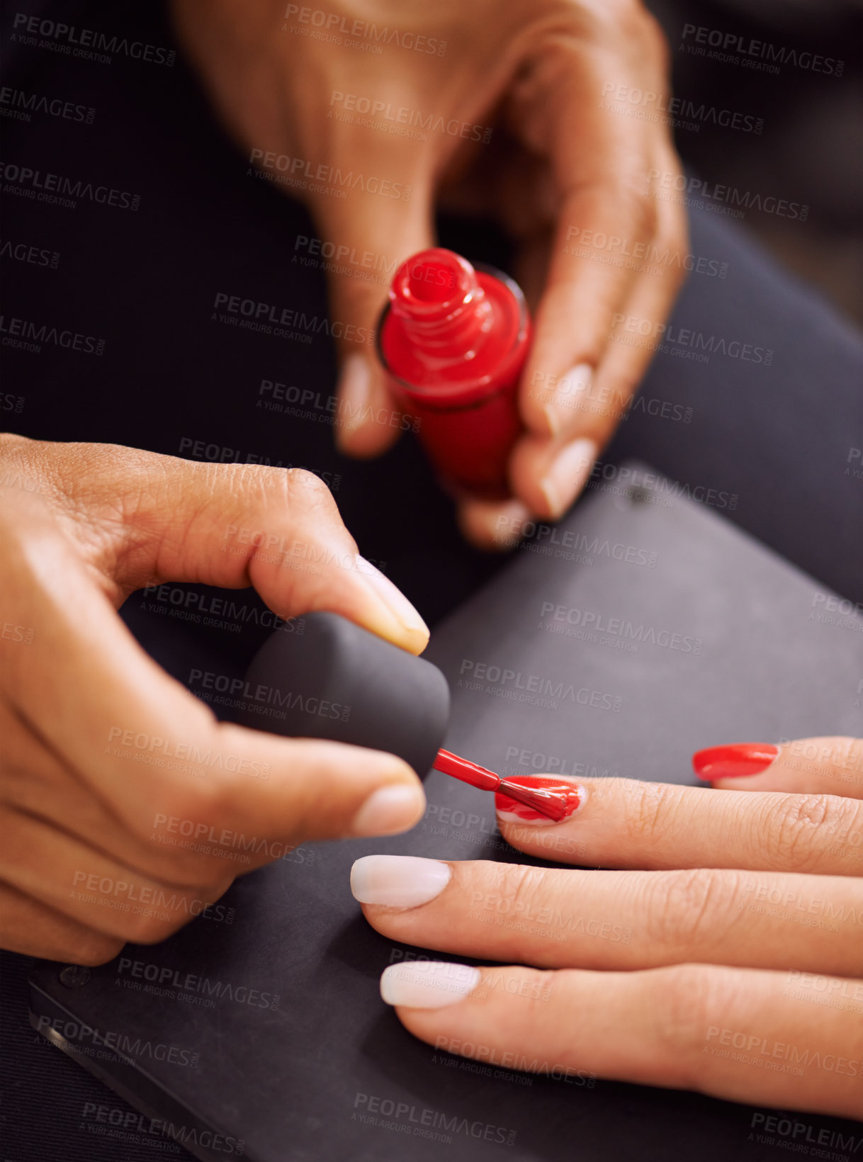 Buy stock photo Closeup of fingernails being painted red