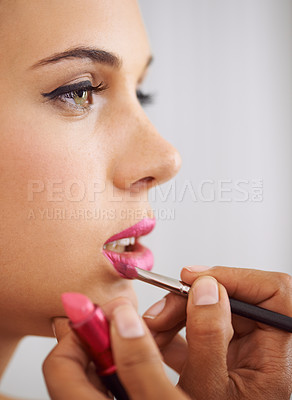 Buy stock photo Cropped shot of a beautiful woman having lipstick applied with a makeup brush