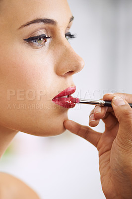 Buy stock photo Face, woman and lipstick brush on lips for beauty with hands, application of cosmetics product and glamour. Woman, mouth and color makeup for skincare, aesthetic makeover and cosmetology at salon