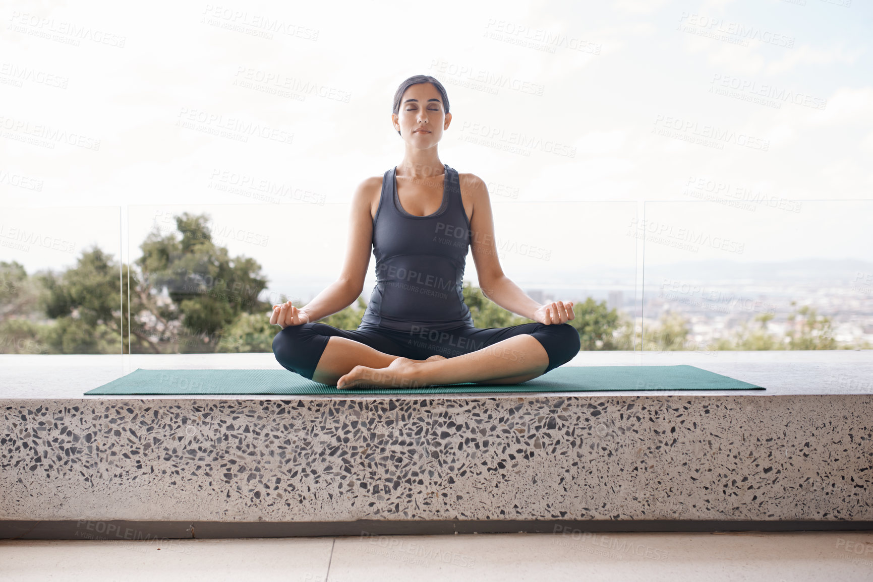 Buy stock photo Shot of a young woman in the lotus position