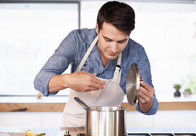 Buy stock photo Shot of a young man enjoying the aroma of his meal
