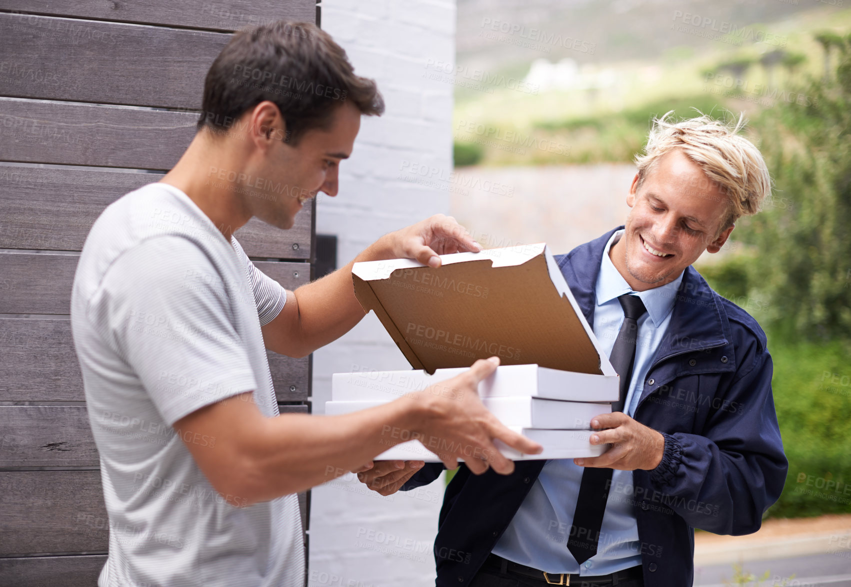 Buy stock photo Men, delivery and giving pizza boxes to customer at gate, home and outdoor for service, fast food and meal. People, happy and together with cardboard package for order by garden at house in Cape Town