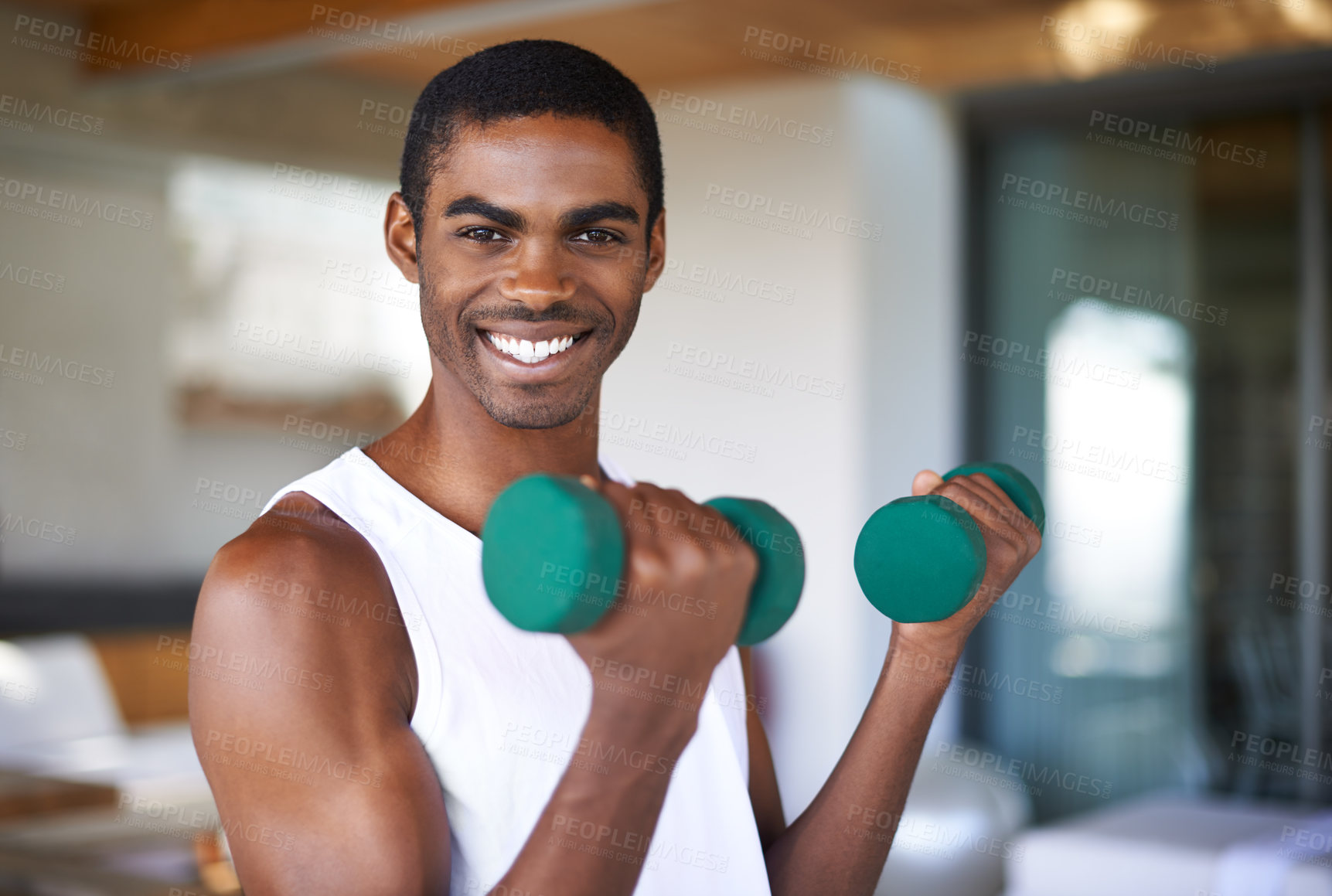 Buy stock photo A fitness shot of a young man toning with weights