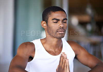 Buy stock photo Shot of a handsome young man exercising in his home