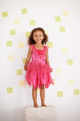 Buy stock photo Child, girl and smile with standing against wall with sticky notes, ottoman and excited with creativity. Kid, female person and happy with playing for development, growth and cute in pink dress