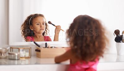 Buy stock photo Shot of a little girl applying blusher in the mirror