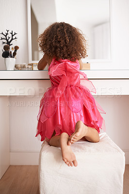 Buy stock photo Rear view shot of a little girl looking at herself in the mirror