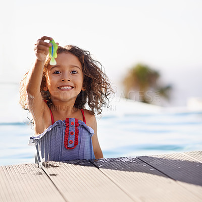 Buy stock photo Portrait of a happy little girl playing by the pool