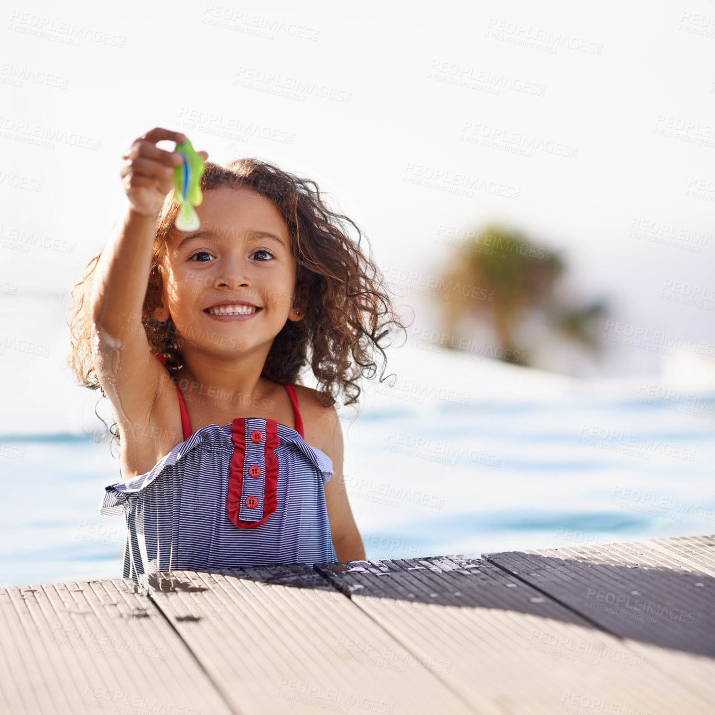 Buy stock photo Portrait of a happy little girl playing by the pool