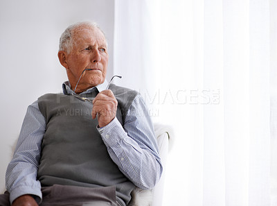 Buy stock photo Old man, thinking and lonely for depression on couch, glasses and remember memories or mistake. Senior male person, living room and nostalgia or anxiety on sofa, dementia and Alzheimer in retirement