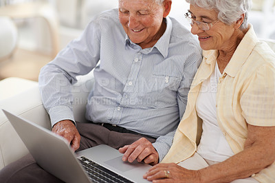 Buy stock photo An aged couple at home using a laptop