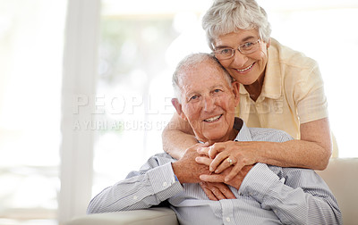 Buy stock photo Couple, senior and hug or sofa in portrait, home and relax together for bonding and smile. Elderly people, embrace and care in marriage or relationship in retirement, loyalty and security on couch