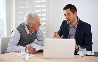 Buy stock photo A young businessman explaining information to an elderly man