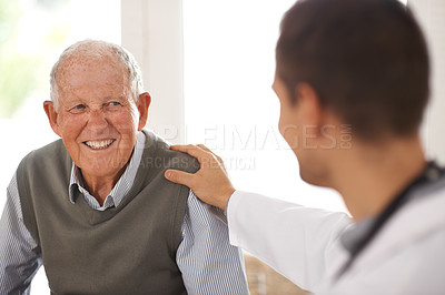 Buy stock photo A doctor and elderly man share a friendly gesture