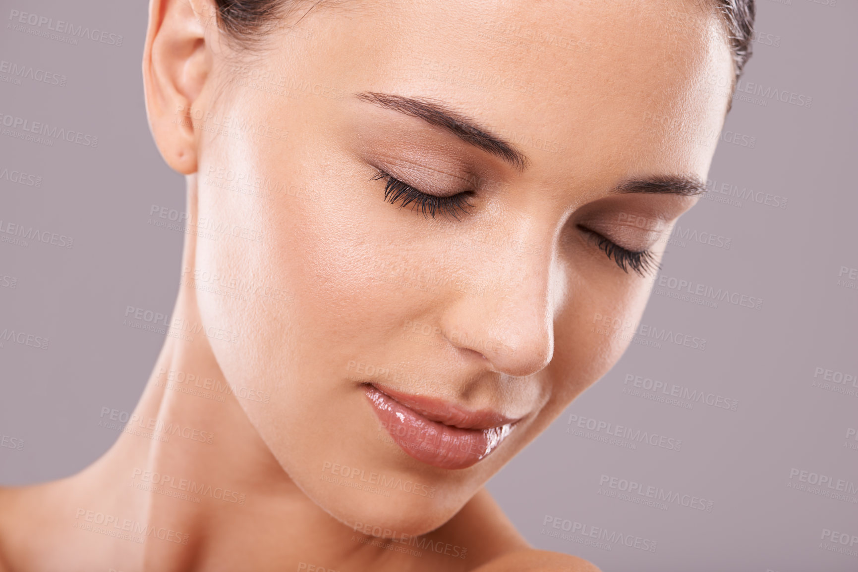 Buy stock photo Beauty shot of a beautiful young woman with perfect skin against a gray background