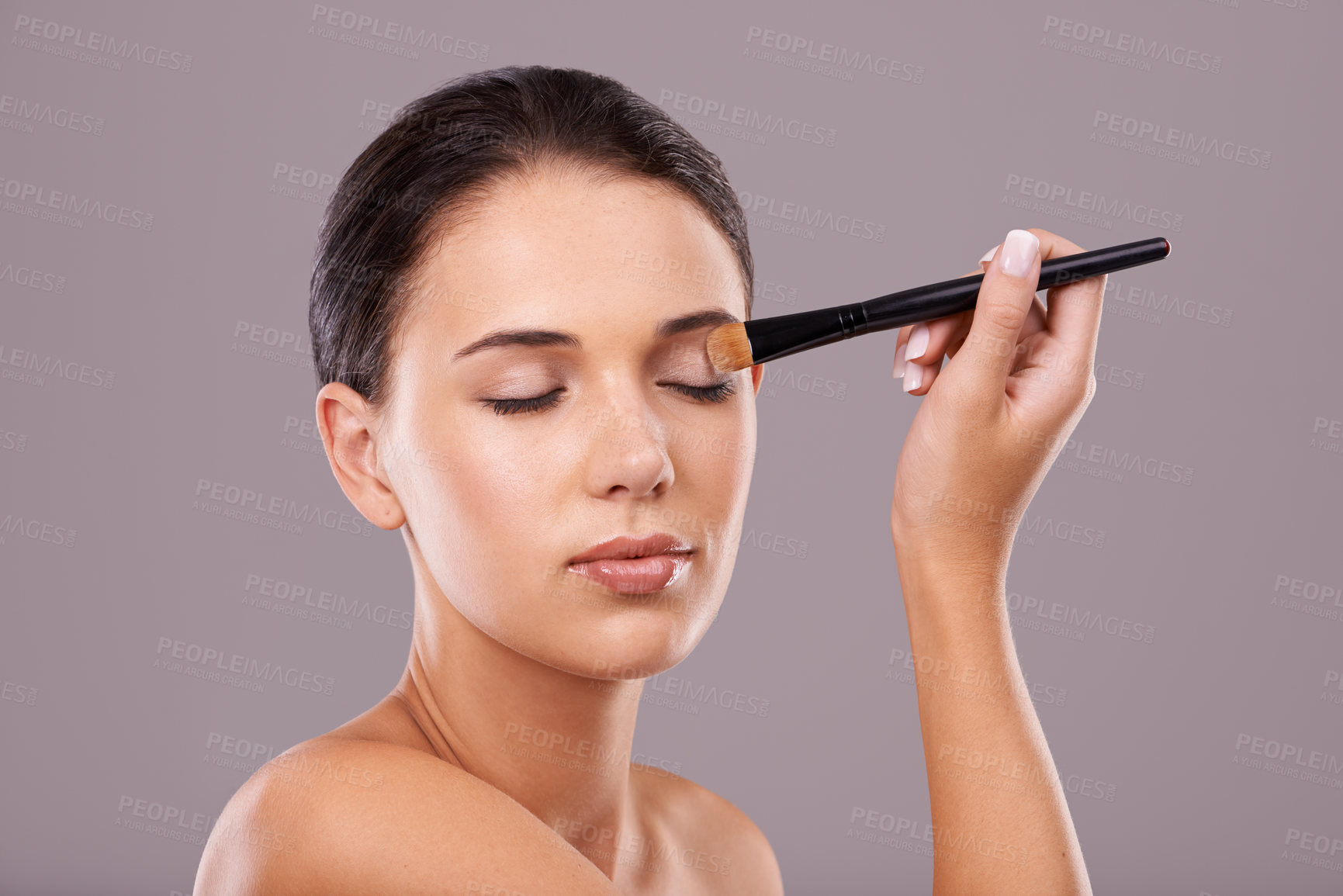 Buy stock photo Woman, hand and brush for eye makeup in studio, skin for eyeshadow and beauty with application on grey background. Cosmetology, transformation and cosmetic care with tools, powder product and shine